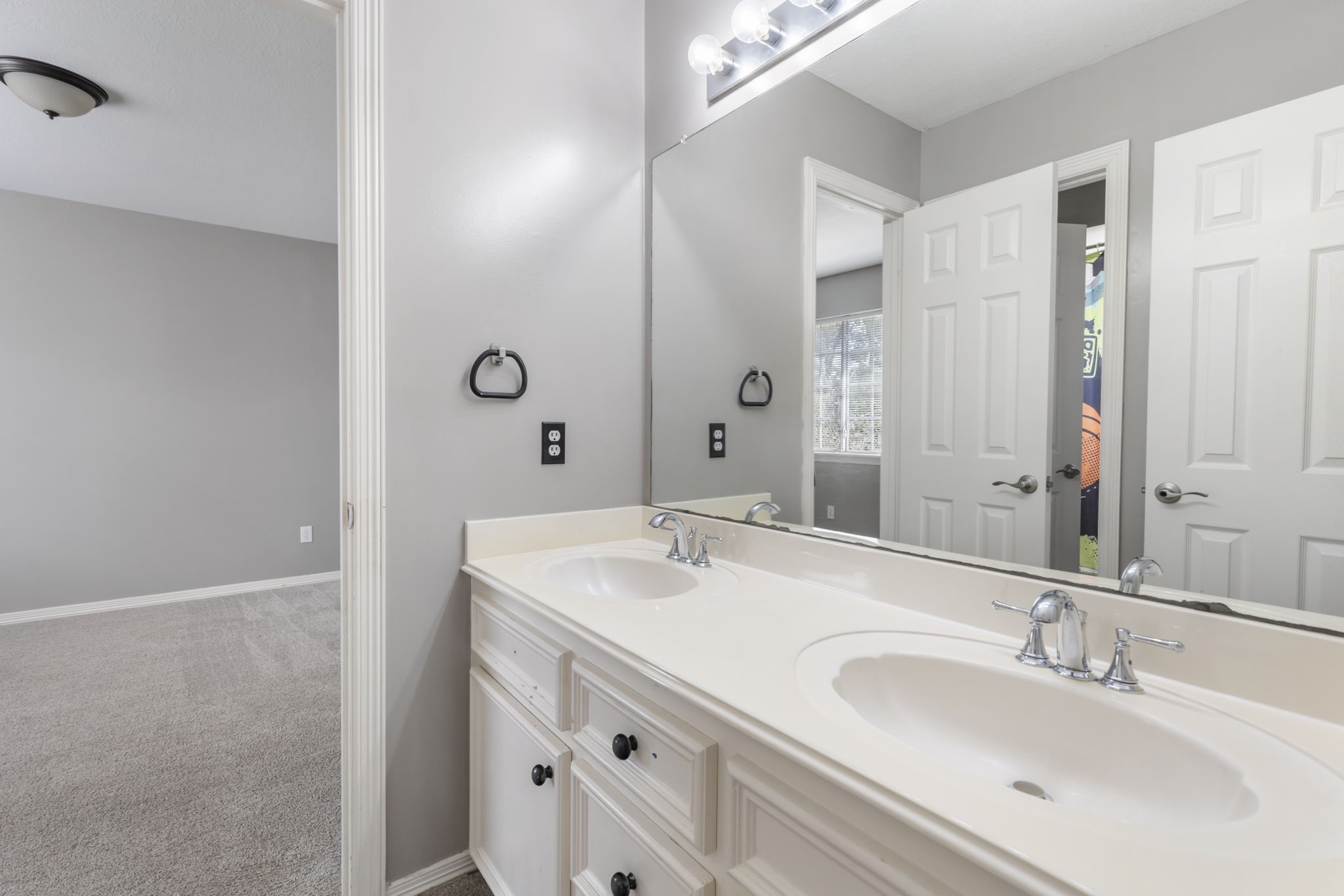 3427 Rolling Terrace Drive Spring, TX 77388 - Photo 27 of 36 a bathroom with a double vanity sink and mirror