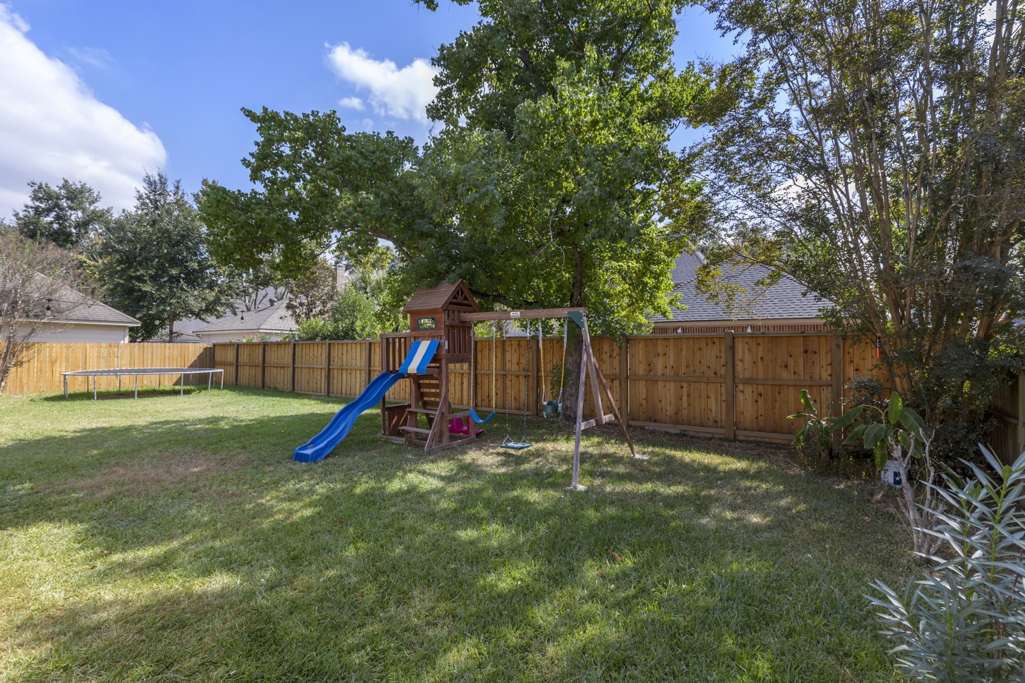 3427 Rolling Terrace Drive Spring, TX 77388 - Photo 34 of 36 a view of a backyard with a slide and a tree