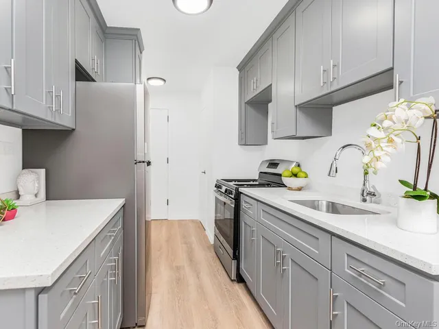 a kitchen with a sink a stove cabinets and refrigerator