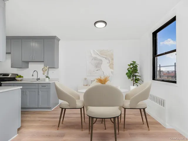 a view of a kitchen with a table and chairs in it