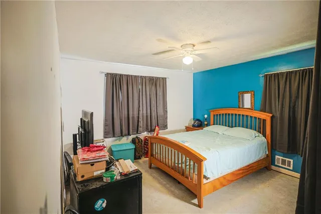 a bed room with a bed and a chandelier