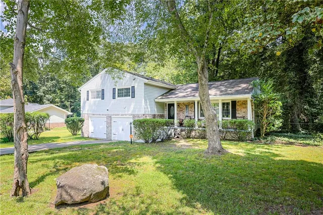 a front view of house with yard and green space