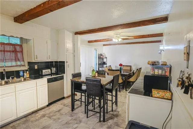 a kitchen with a table and chairs in it