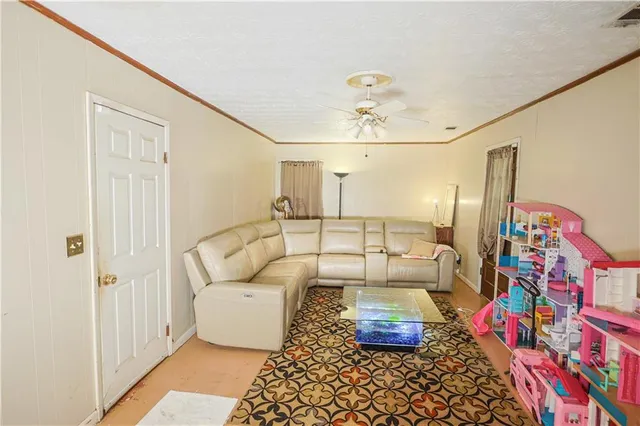 a living room with furniture and painting on the wall