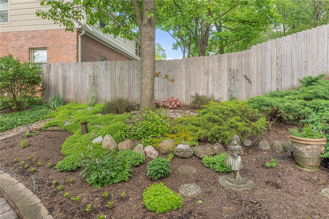 156 West Hadley Road Dayton, OH 45419 - Photo 50 of 71 This tranquil yard features a sturdy wooden fence and lush green landscaping.