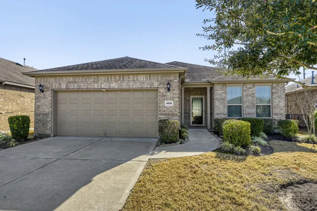 a view of a house with potted plants