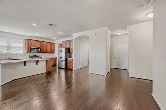 a view of kitchen with refrigerator stove microwave and cabinets