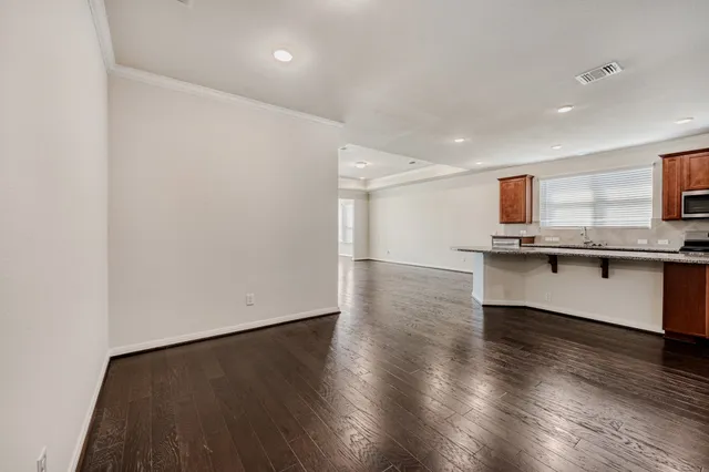 a view of kitchen with wooden floor and electronic appliances