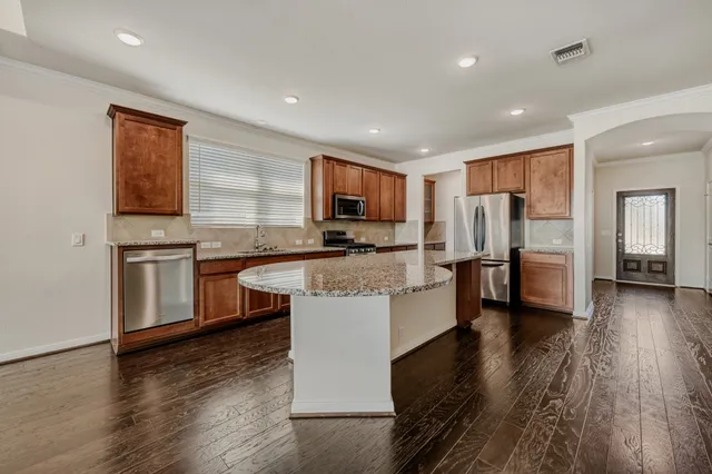 a kitchen with granite countertop counter top space a sink stainless steel appliances and cabinets