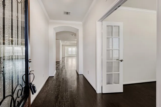 a view of a hallway with wooden floor