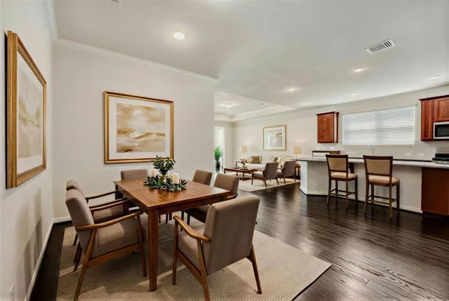 a view of a dining room with furniture and wooden floor