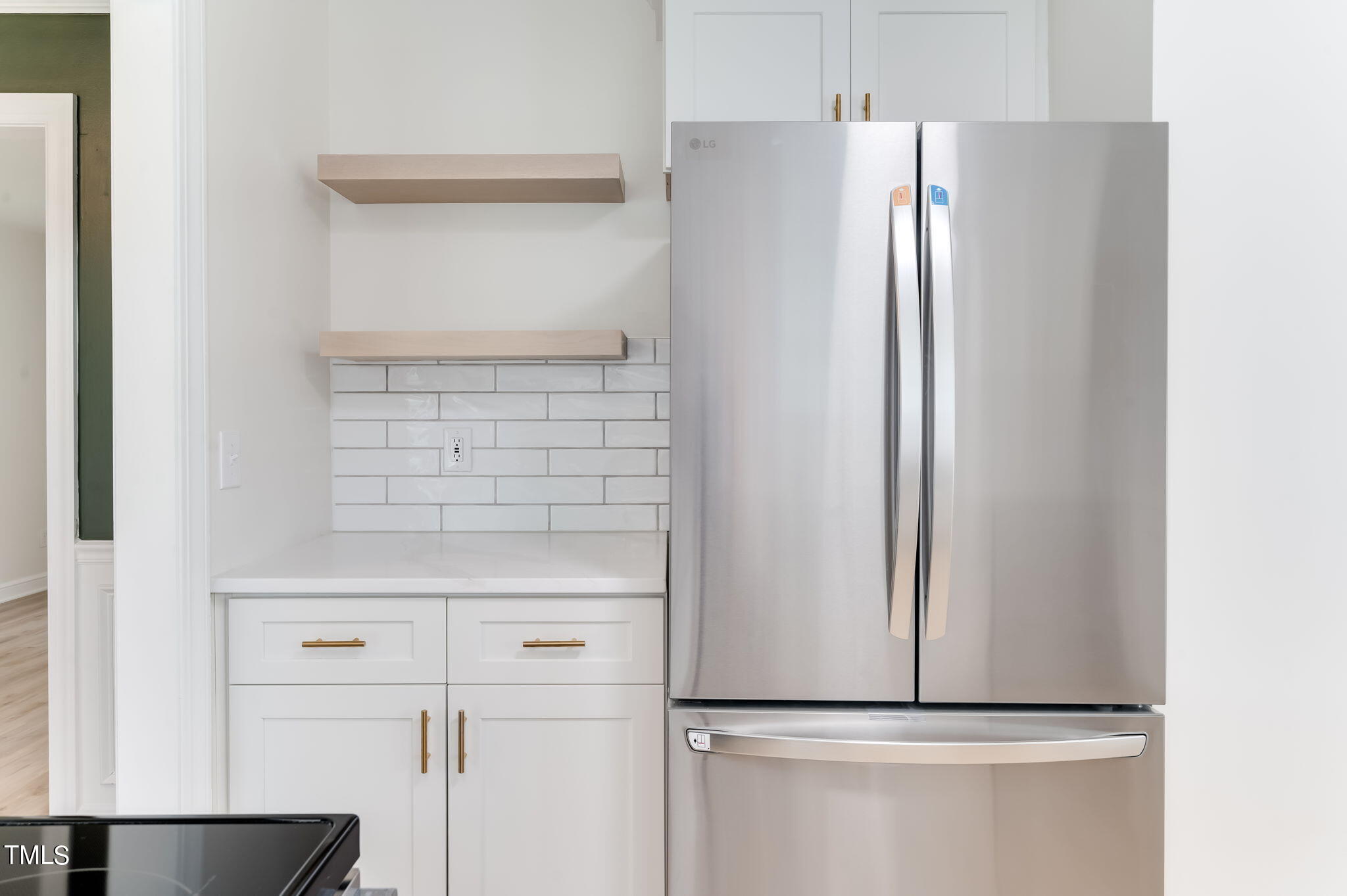 3912 Kildaire Farm Road Apex, NC 27539 - Photo 16 of 37 a close view of a refrigerator in kitchen and white cabinets