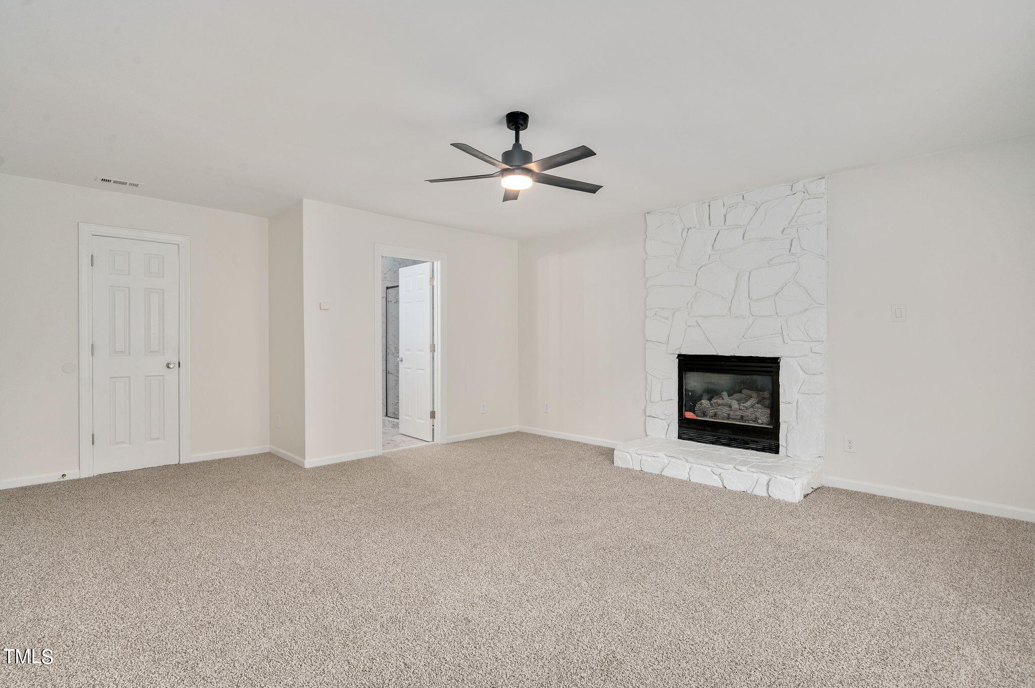 3912 Kildaire Farm Road Apex, NC 27539 - Photo 23 of 37 a view of an empty room with a ceiling fan and a ceiling fan
