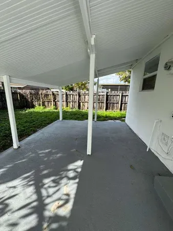 a view of a house with porch and a yard