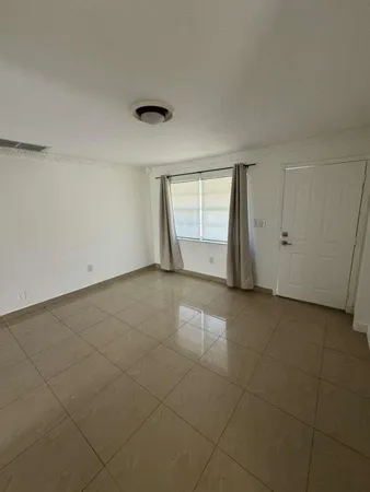 an empty room with a empty space and window