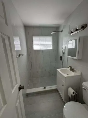 a bathroom with a sink toilet and shower