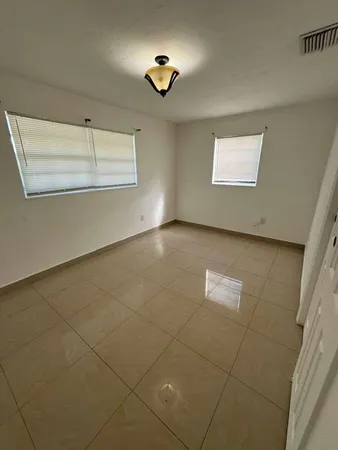 a view of a livingroom with a ceiling fan and window