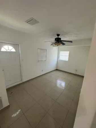 a view of a livingroom with a ceiling fan and window