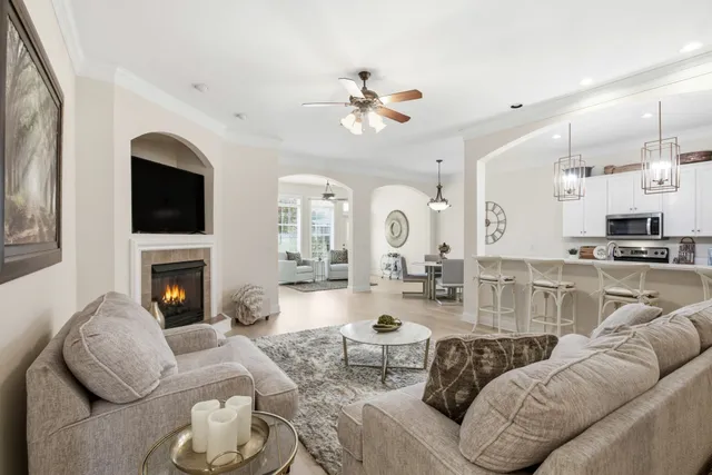a living room with furniture a fireplace and a flat screen tv