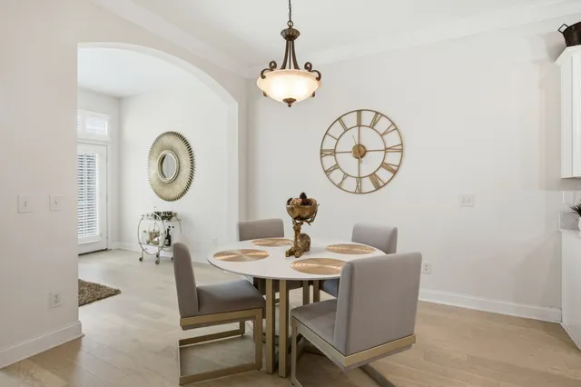 a dining room with furniture and a mirror
