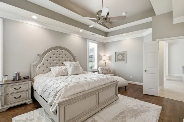 a bedroom with a large bed and a chandelier