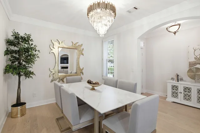 a view of a dining room with furniture and chandelier