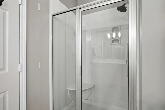 a bathroom with a glass shower door