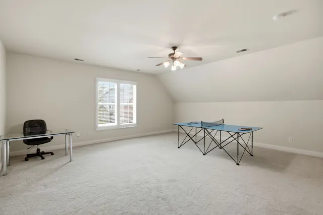 a view of a room with gym equipment and window
