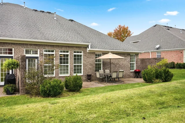 a front view of a house with patio and garden
