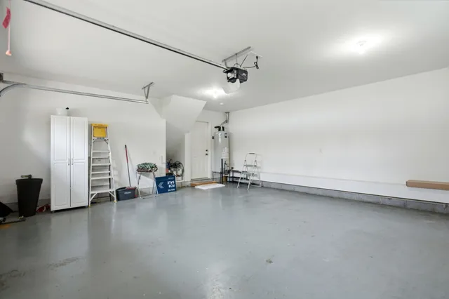an empty room with stairs and wooden floor