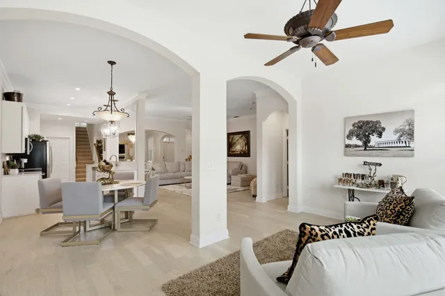 a bedroom with a bed a couch and a chandelier