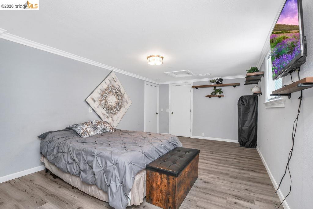2191 East Cypress Road Oakley, CA 94561 - Photo 20 of 48 Bedroom featuring light wood-style flooring and crown molding