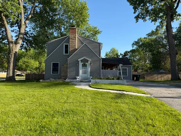 a front view of a house with swimming pool having outdoor seating