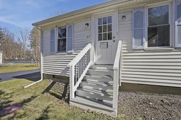 a view of a house with a door and a yard