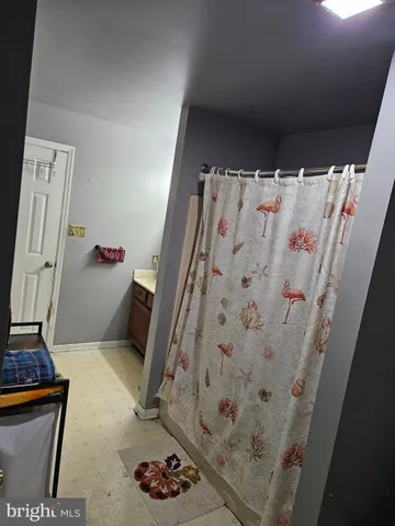 a bathroom with a granite countertop sink a toilet and a mirror