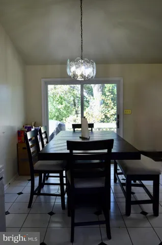 a view of a dining room with furniture and a chandelier