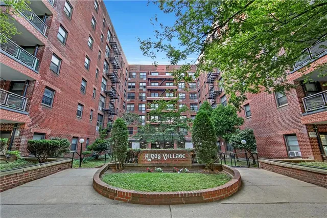 a view of a water fountain in front of brick building