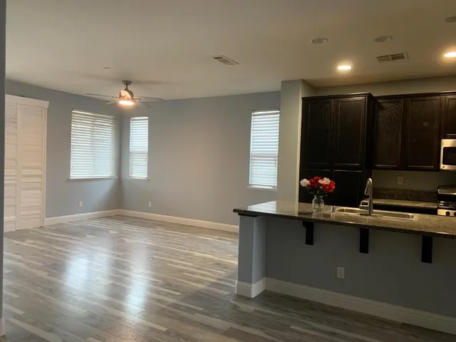 a kitchen with a sink window and cabinets