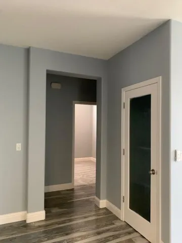 a view of hallway with wooden floor