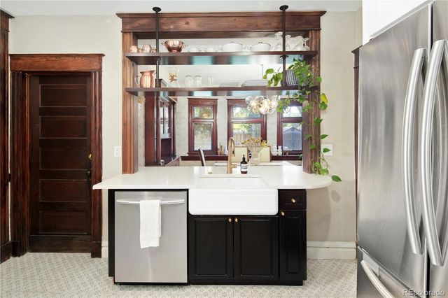 a kitchen with a stove cabinets and a refrigerator