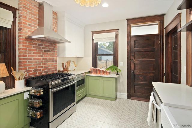 a kitchen with stainless steel appliances a refrigerator and a stove top oven