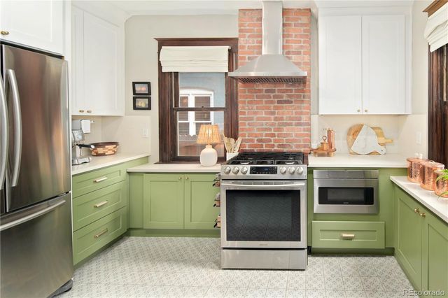 a kitchen with a sink a large window and a dining table