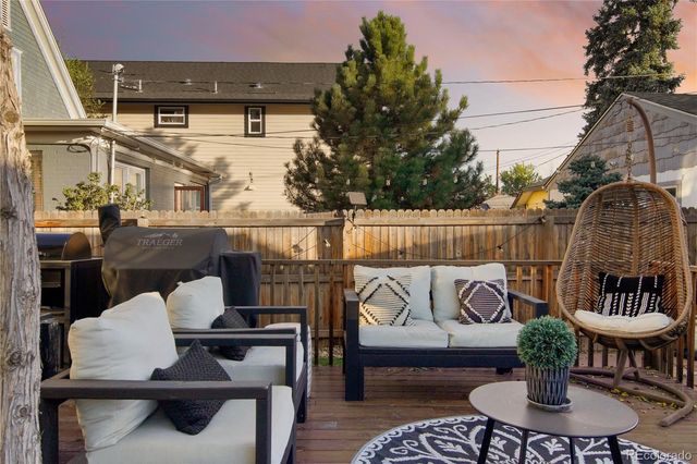 a view of backyard with a patio and outdoor seating