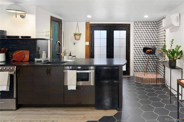 a kitchen with stainless steel appliances granite countertop a stove a sink dishwasher and a refrigerator