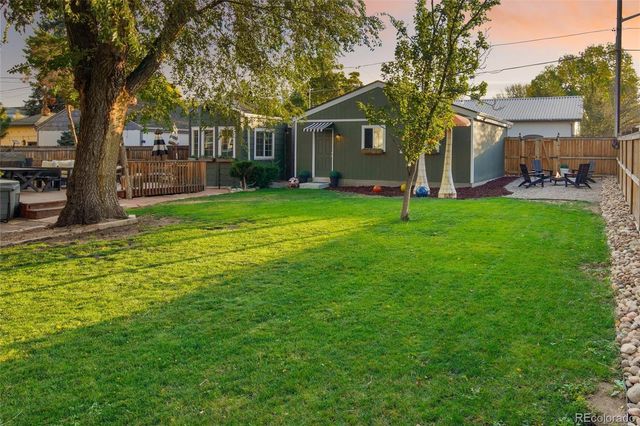 a aerial view of a house with a swimming pool and outdoor seating