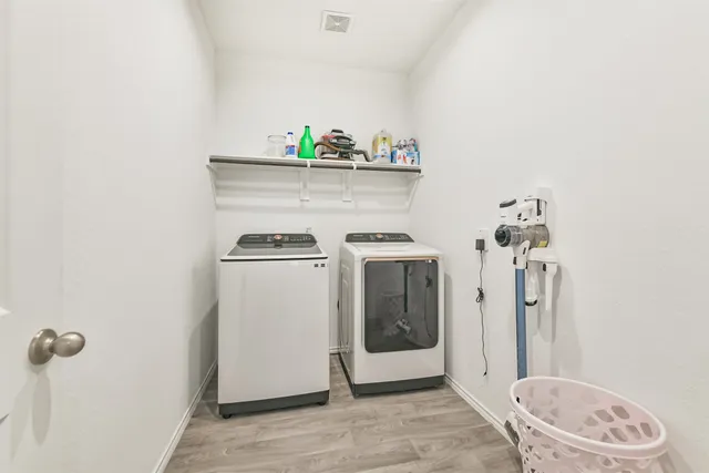 a utility room with a sink a washer and dryer
