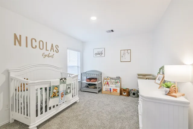 a bedroom with furniture and a baby crib