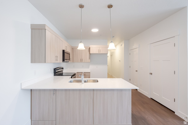 693 West 4500th South, Unit O202 Mapleton, UT 84664 - Photo 14 of 16 Kitchen featuring light wood finish cabinets, a peninsula, pendant lighting, stainless steel appliances, and dark wood finished floors