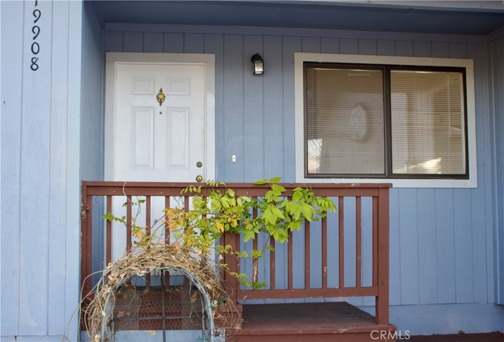 19908 Bear Valley Road Hidden Valley Lake, CA 95467 - Photo 2 of 50 a vase of flowers sitting on a table in front of a door