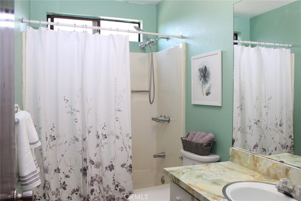 19908 Bear Valley Road Hidden Valley Lake, CA 95467 - Photo 29 of 50 a bathroom with a sink and a mirror